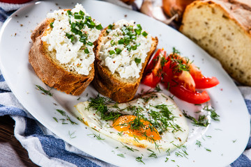 Breakfast - fried egg, toasts and vegetable salad