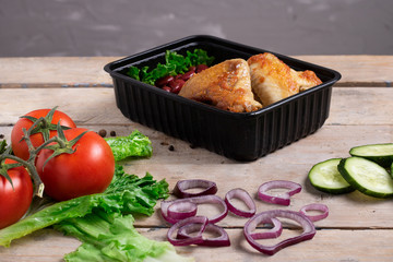 red onion, cucumber and tomatoes near grilled chicken. Chalk background