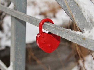 Red lock heart on a bridge