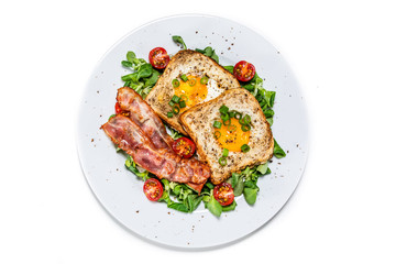 Breakfast - toasted bread with fried egg, bacon and vegetables