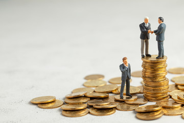 Businessmen shake hands as a symbol of a successful profitable transaction. Businessmen on a stack...