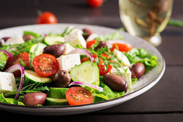 Greek salad with fresh vegetables, feta cheese and kalamata olives. Healthy food.