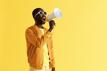 Advertising. Man screaming announcement in megaphone portrait