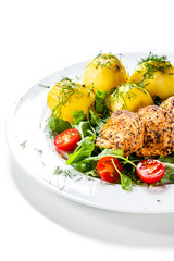 Grilled chicken fillet and vegetables on white plate