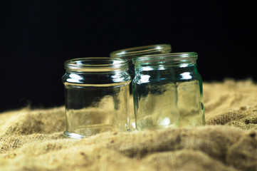 glass jars on a black background for storing food for the winter