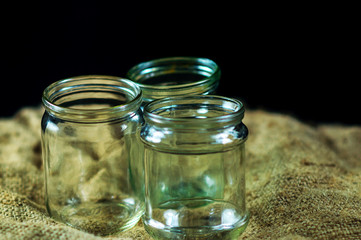 glass jars on a black background for storing food for the winter