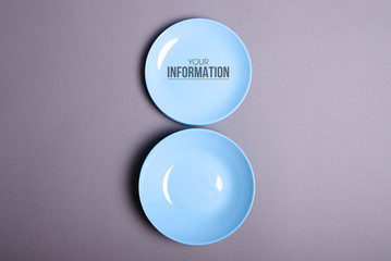 Blue empty plate on gray background, space for text