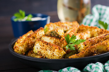 Baked zucchini sticks with cheese and bread crumbs. Vegan food. Vegetarian cuisine.