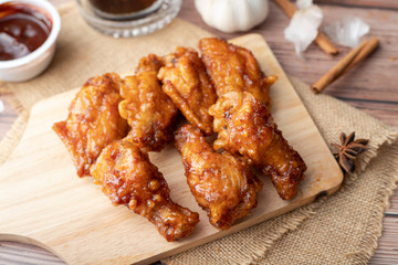 Hot and spicy Korean barbeque fried chicken on wood cutting board