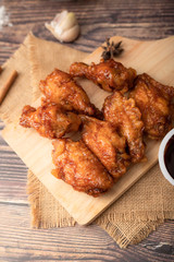 Hot and spicy Korean barbeque fried chicken on wood cutting board