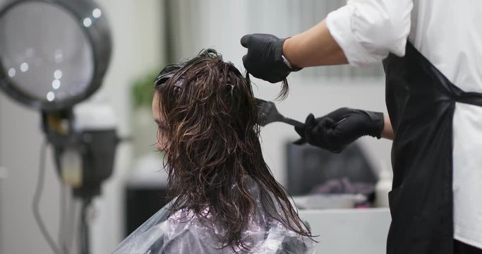 Woman have hair treatment, color dye on hair at beauty salon