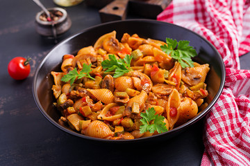 Conchiglie pasta. Italian pasta shells with mushrooms, zucchini and tomato sauce.