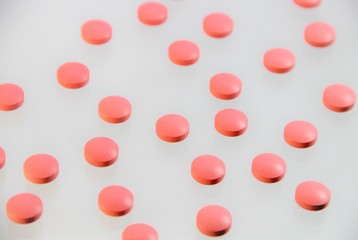 pink pills on white background