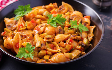 Conchiglie pasta. Italian pasta shells with mushrooms, zucchini and tomato sauce.