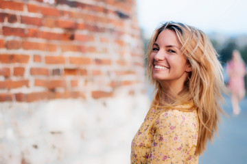 Beautiful young cheerful, happy woman in summer in the city. focus, blur.