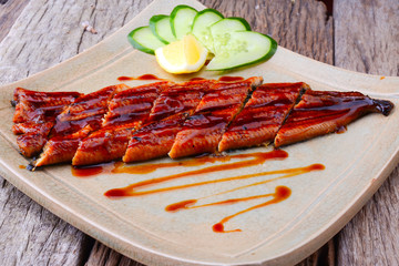 Grilled Japanese eel with sweet sauce and served on a plate