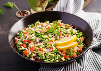Tabbouleh salad. Traditional middle eastern or arab dish. Levantine vegetarian salad with parsley, mint, bulgur, tomato.