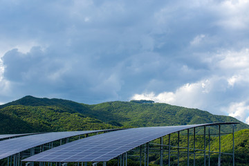Solar energy panels and green mountain.