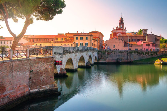 Tiberius bridge in Rimini historic centre, Italy. Scenic ancient stone bridge in morning sunrise