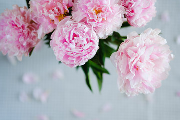Fototapeta premium pink flowers lie on the table on a gray napkin