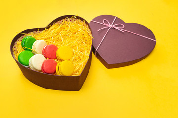 Macaroons in a gift box. Heart-shaped box. Copy space.