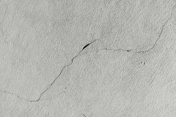 Texture. An old concrete wall with a crack leading diagonally across the image.