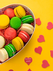 Macaroons in a gift box. Heart-shaped box. Copy space.