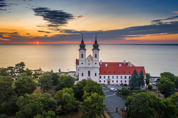 Tihany, Hungary - Aerial skyline view of the famous Benedictine Monastery of Tihany (Tihany Abbey) with beautiful colourful sky and clouds at sunrise over Lake Balaton
