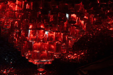 Red Bottles glowing under the ceiling