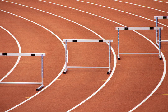 Hurdles on a bend of an athletics stadium race track