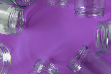 Isolated glass jars, no lids flat, violet purple background, copy space room