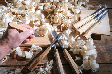 Carpentry tools for wood processing, shavings on a wooden table.