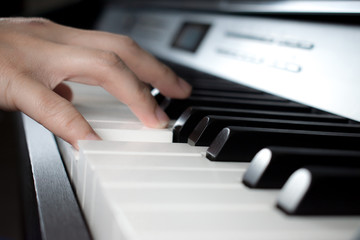 Musician playing the piano. Close up to the hand.