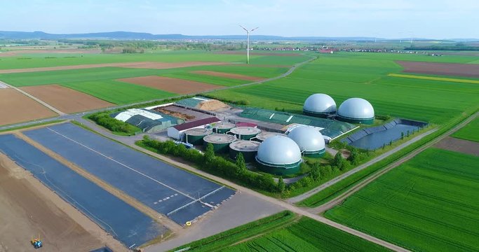 Camera flight over biogas plant from pig farm. Renewable energy from biomass. Modern agriculture European Union