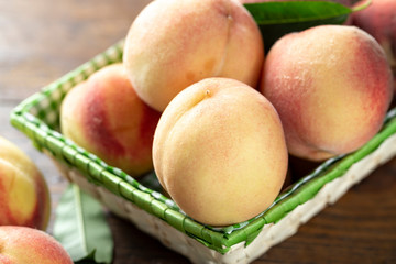 Fresh sweet peaches on the wooden table