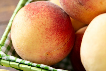 Fresh sweet peaches on the wooden table