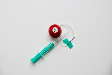 Fototapeta na wymiar green transparent syringe with needle butterfly red bullet number seven billard push pin on white