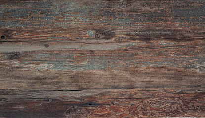 Texture of old dark wooden board with several rusty nails.