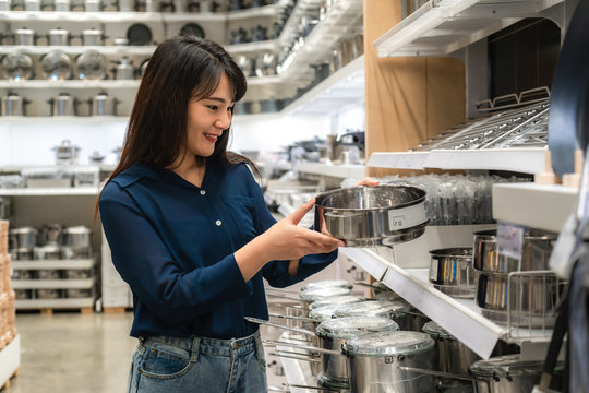 Asian women are choosing to buy new kitchenware in the mall. Shopping for groceries and housewares are needed in markets, supermarkets or big shopping centres.