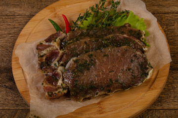Raw marinated pork steak