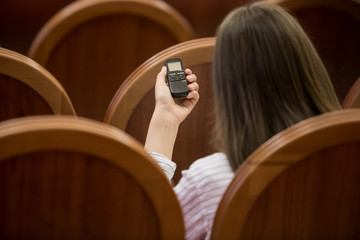 a voice recorder in the hand of a journalist