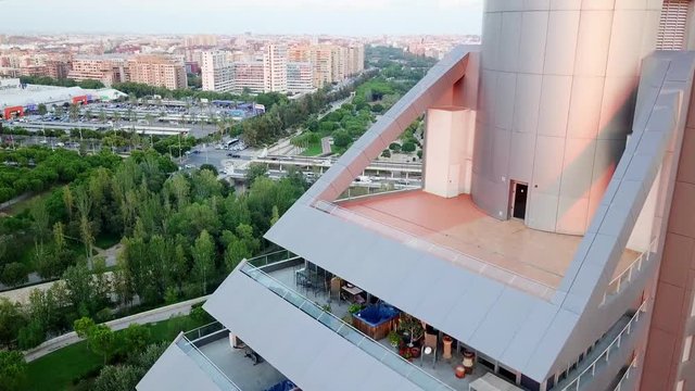 Aerial overview of modern, futuristic building and view of European city and park Turia, shot in Valencia - Spain