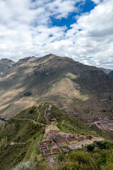 Landscape with green Andean Mountains and Inca ruins on the hiking path in Pisac archeological park, Peru