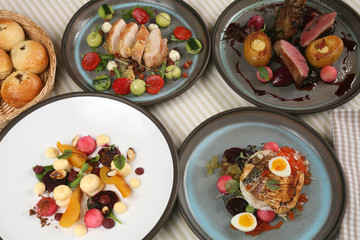 Contemporary cuisine, bread, autumn vegetable salad, chicken breast starter, goose fillet, smoked catfish