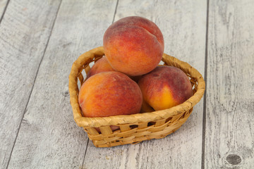 Peach heap in the wooden basket