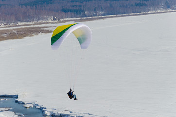 Paragliding in the sky.paraglider fly over the mountain valley. Competitions with paragliding, Russia, Siberia