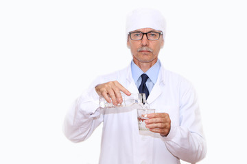 Healthy Eating - Doctor pours mineral water into a glass