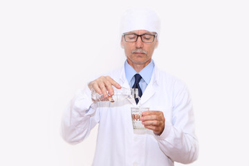 Healthy Eating - Doctor pours mineral water into a glass