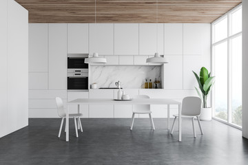 White kitchen interior, counters and table