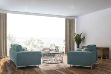 White living room corner, blue sofa